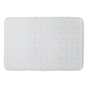 A completely white, featureless surface fills the  bath mat