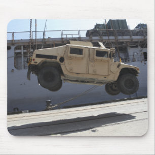 A crane lifts an M998 Humvee Mouse Mat