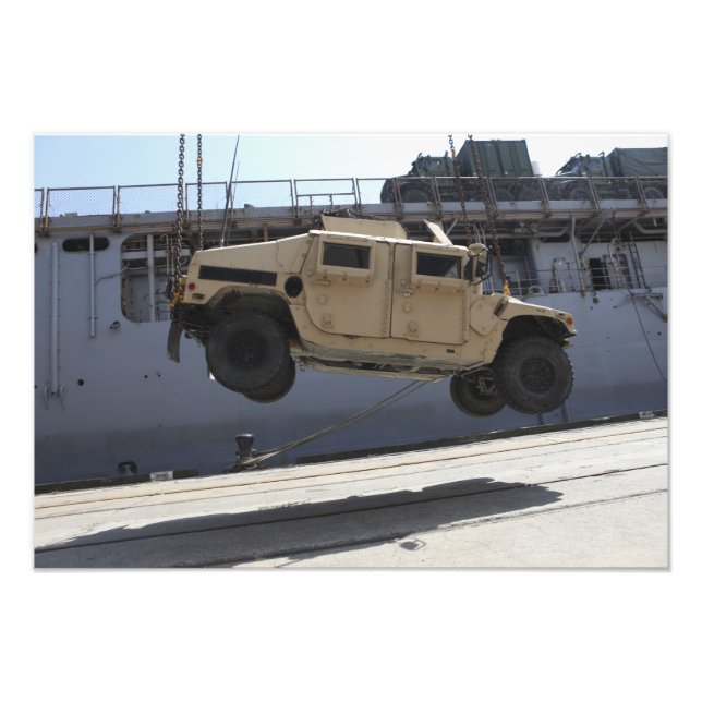 A crane lifts an M998 Humvee Photo Print (Front)