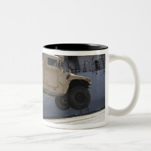 A crane lifts an M998 Humvee Two-Tone Coffee Mug