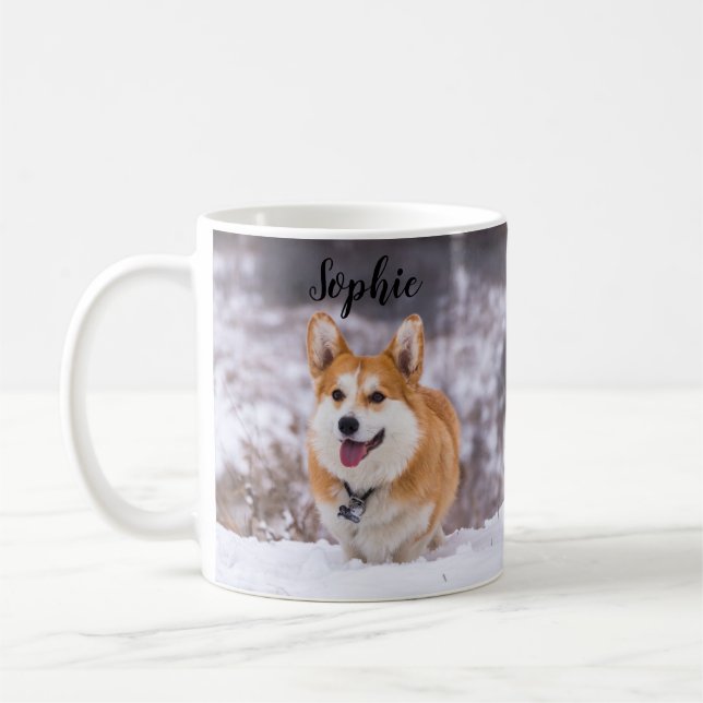 A Cute Pembroke Welsh Corgi Frolicking in the Snow Coffee Mug (Left)