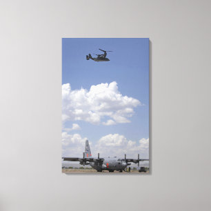 A CV-22 Osprey flies over a C-130 Hercules Canvas Print