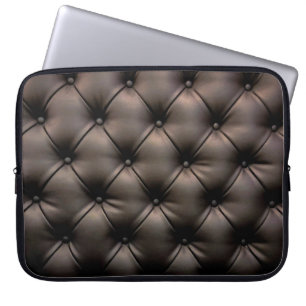 A dark leather cushion background, from a car seat laptop sleeve
