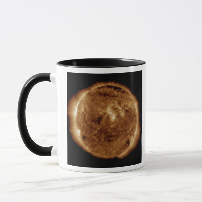A dark rift in the sun's atmosphere mug (Left)