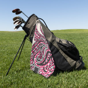 A decorative paisley design with vivid red and pin golf towel
