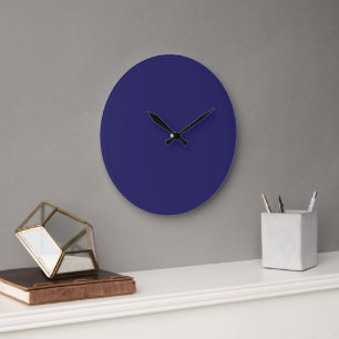 A deep blue backdrop accented by a white border, o large clock