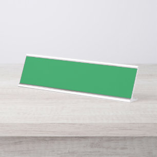 A dense, lush forest filled with vibrant green tre desk name plate