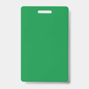 A dense, lush forest filled with vibrant green tre ID badge
