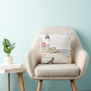A dog plays at the beach near the lighthouse cushion