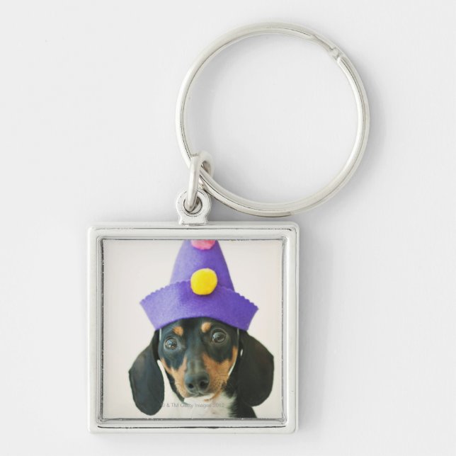 A dog wearing a funny hat key ring (Front)