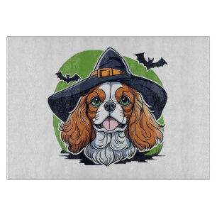 A dog wearing a witches hat with bats cutting board