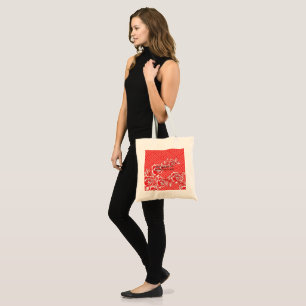 A fashionable scarf displaying a red and black des tote bag