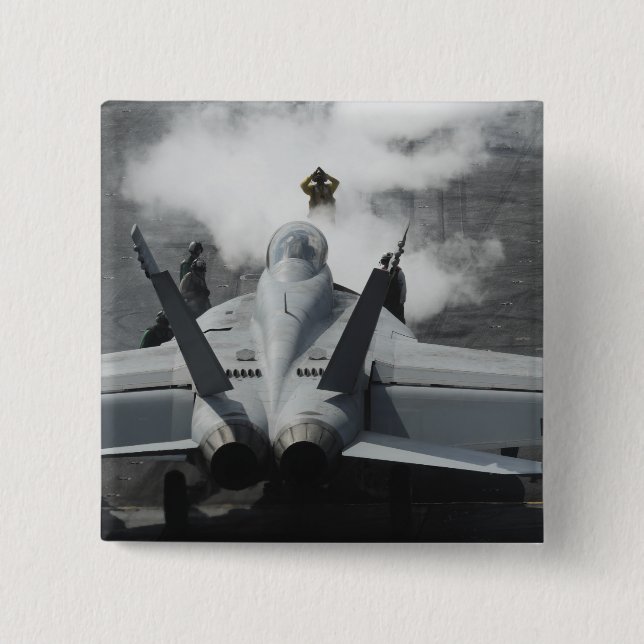 A flight deck director signals an F/A-18F 15 Cm Square Badge (Front)