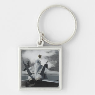 A flight deck director signals an F/A-18F Key Ring