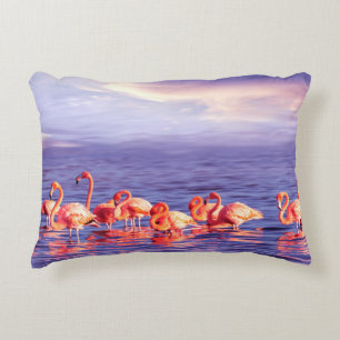 A flock of beautiful pink flamingos against a purp decorative cushion