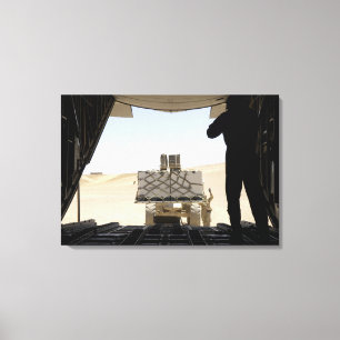 A forklift loads cargo onto a C-130 Hercules Canvas Print