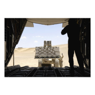 A forklift loads cargo onto a C-130 Hercules Photo Print