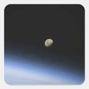 A gibbous moon visible above Earth's atmosphere 2 Square Sticker