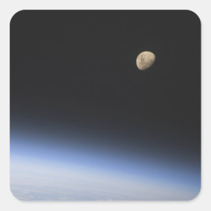 A gibbous moon visible above Earth's atmosphere Square Sticker