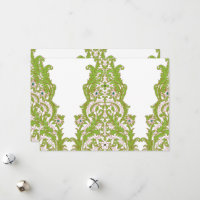 a green and white wallpaper with ornate designs