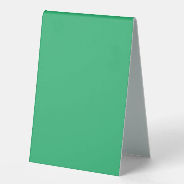 a green background with a white border (Front)