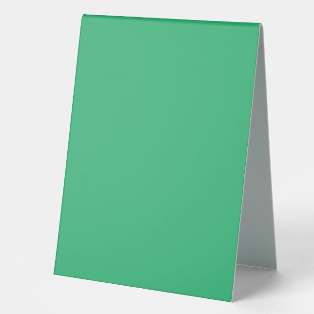 a green background with a white border (Front)
