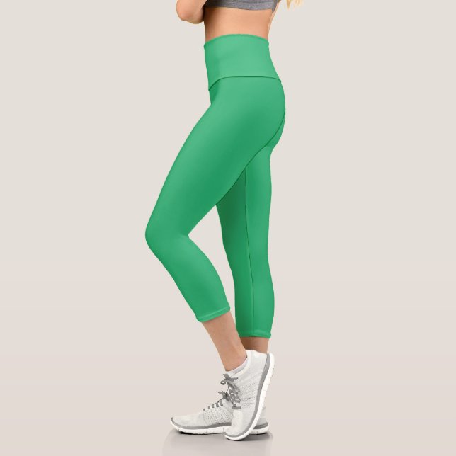 a green background with a white border capri leggings (Left)