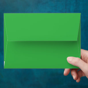 a green background with a white border envelope