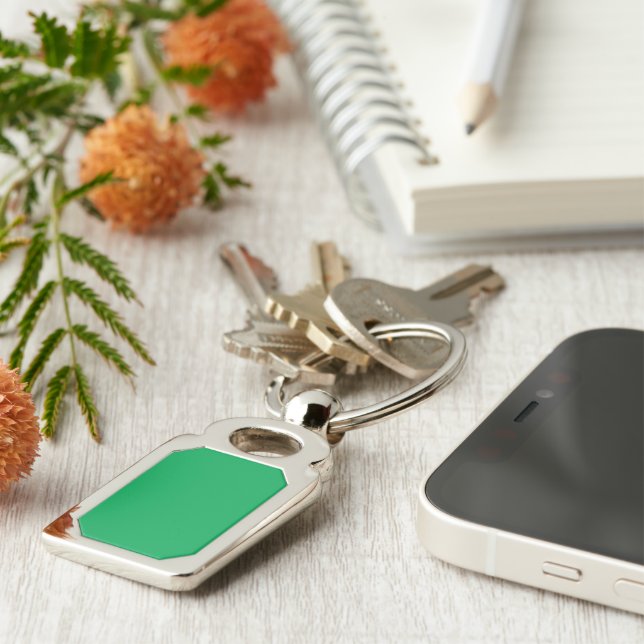 a green background with a white border key ring (Side)