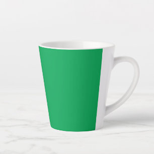 a green background with a white border latte mug