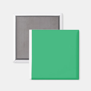 a green background with a white border magnet