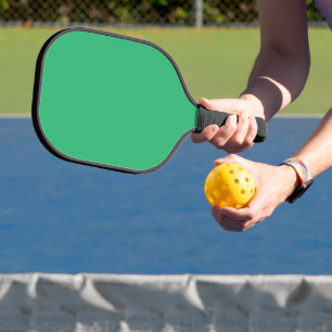 a green background with a white border pickleball paddle