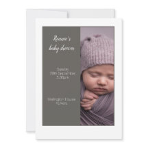 A grey coloured baby shower invitation card