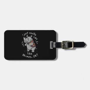 A grey rhinoceros with a mischievous grin luggage tag