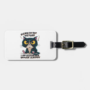 A grumpy cat with oversized luggage tag