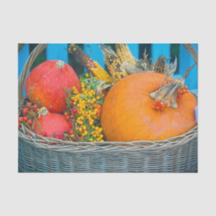 A holiday basket with pumpkins tissue paper