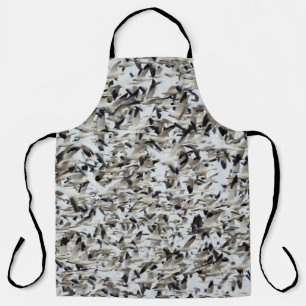 A HUGE DENSE FLOCK OF SNOW GEESE FLY TOGETHER IN T APRON