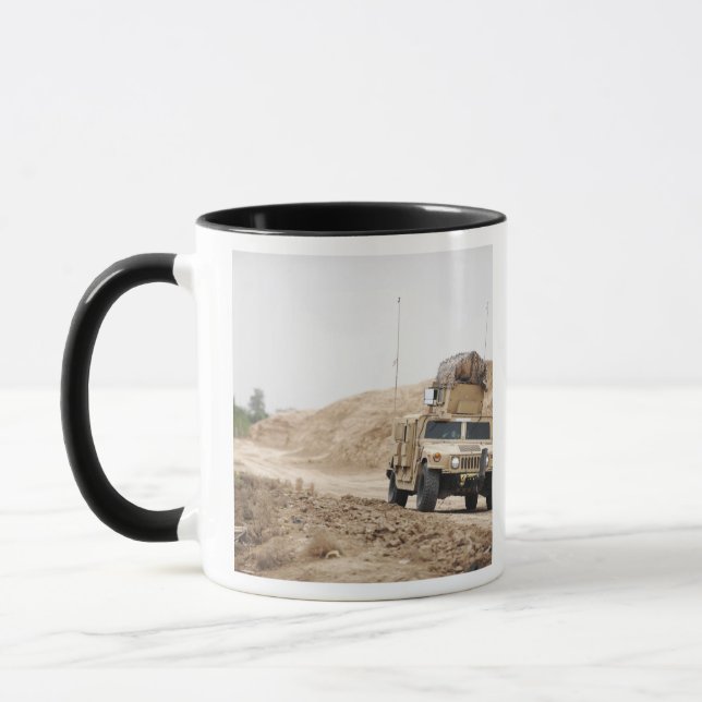 A Humvee conducts security Mug (Left)