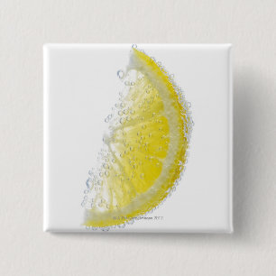 A juicy ripe organic lemon wedge fruit submerged 15 cm square badge
