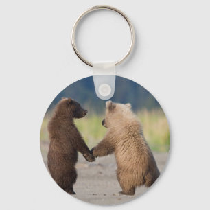 A key chain of two bears holding hands