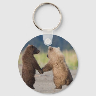 A key chain of two bears holding hands