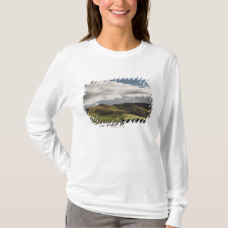 A Landscape With Rolling Hills And Clouds Overhead T-Shirt
