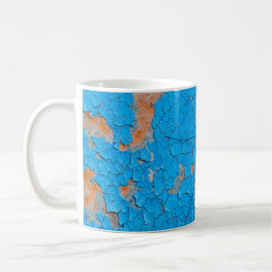 A large mosquito sits on an blue old cracked walla coffee mug