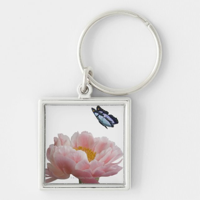a large pink peony is visited by a ethereal key ring (Front)
