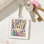 A Little Bit Dramatic Funny Groovy Saying Key Ring<br><div class="desc">A Little Bit Dramatic Funny Groovy Saying Typography Keychain features the text "A Little Bit Dramatic" in modern typography on a pink chequerboard background with groovy flowers,  lightening bolts and a smiling face. Designed by Evco Studio www.zazzle.com/store/evcostudio</div>