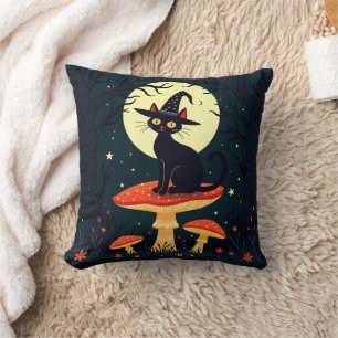 A Little Black Witchy Cat Sitting On A Toadstool Cushion
