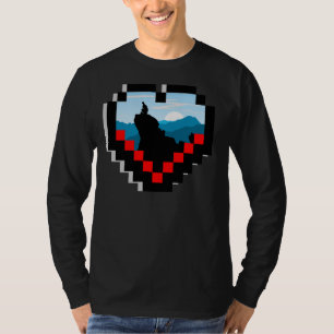 A lone figure sitting on a mountain peak at sunris T-Shirt