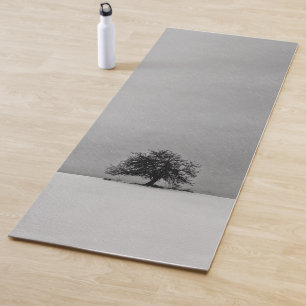 A lonely tree in black and white yoga mat