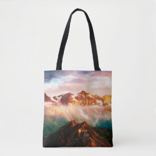 A look at the sunlit hills at twilight. Dramatic e Tote Bag