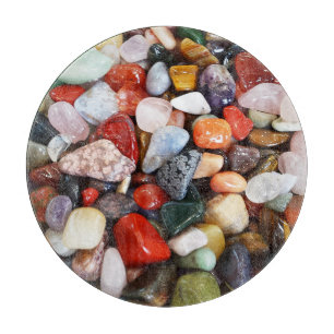 a lot of beautifully coloured stones cutting board